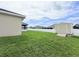 Side view of a well-maintained backyard featuring a shed, fence, lawn and patio, ideal for outdoor activities at 186 Nw 44Th St, Ocala, FL 34475