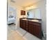 Bathroom featuring double sinks, framed mirror, and tile flooring at 186 Nw 44Th St, Ocala, FL 34475
