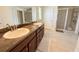 Bathroom featuring a double vanity, framed mirrors, and walk-in shower at 186 Nw 44Th St, Ocala, FL 34475