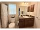 Well-lit bathroom boasts a vanity with ample storage, granite countertops, a shower with curtain and a window at 186 Nw 44Th St, Ocala, FL 34475