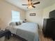 Comfortable bedroom featuring a queen-size bed, side table, dresser and natural light at 186 Nw 44Th St, Ocala, FL 34475