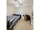 Cozy bedroom with a striped bedspread, ample natural light, and minimalist decor at 186 Nw 44Th St, Ocala, FL 34475