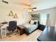 Cozy bedroom featuring a ceiling fan, desk and chair, and a comfortable bed with neutral tones and soft textures at 186 Nw 44Th St, Ocala, FL 34475