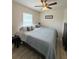 Comfortable bedroom featuring a queen-size bed, side table, dresser and natural light at 186 Nw 44Th St, Ocala, FL 34475