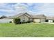 Landscaped yard showcases a charming, neutral-colored home with lush green grass at 186 Nw 44Th St, Ocala, FL 34475