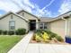 Inviting walkway leads to the front door, framed by lush landscaping and tasteful exterior details at 186 Nw 44Th St, Ocala, FL 34475