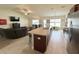 Open kitchen with granite counters, stainless appliances, and breakfast bar overlooking living area at 186 Nw 44Th St, Ocala, FL 34475