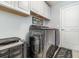 Convenient laundry room with modern washer and dryer, white cabinets, and stylish decor at 186 Nw 44Th St, Ocala, FL 34475