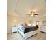 Bright main bedroom with tray ceiling, fan, and white furniture at 186 Nw 44Th St, Ocala, FL 34475
