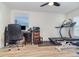 Functional office and exercise space with desk, treadmill, and bright overhead lighting at 186 Nw 44Th St, Ocala, FL 34475