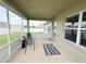 Enclosed screened patio with seating and plenty of natural light, perfect for relaxing outdoors at 186 Nw 44Th St, Ocala, FL 34475