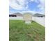 Backyard storage shed surrounded by a green lawn and a white fence, providing ample outdoor storage at 186 Nw 44Th St, Ocala, FL 34475