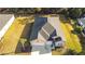 Aerial view of a well-maintained home with a two-car garage and green lawn at 19551 Sw 77Th Loop, Dunnellon, FL 34432