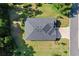 This is an aerial view of a well maintained property featuring a new roof, healthy lawn, and concrete driveway at 19551 Sw 77Th Loop, Dunnellon, FL 34432