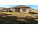 A spacious backyard with a screened-in lanai provides a view of the lawn at 19551 Sw 77Th Loop, Dunnellon, FL 34432
