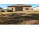 A spacious backyard with a screened-in lanai provides a view of the lawn at 19551 Sw 77Th Loop, Dunnellon, FL 34432