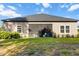 Spacious backyard with a screened-in patio, lush grass and a well-maintained lawn at 19551 Sw 77Th Loop, Dunnellon, FL 34432