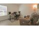 Neutral bedroom features a desk, chair, and a window for natural light at 19551 Sw 77Th Loop, Dunnellon, FL 34432