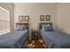 Sunlit bedroom with twin beds, wood style flooring, and stylish decor at 19551 Sw 77Th Loop, Dunnellon, FL 34432
