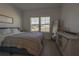 Cozy bedroom with natural light from a window and wood-look flooring at 19551 Sw 77Th Loop, Dunnellon, FL 34432