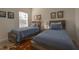 Comfortable bedroom with twin beds and wood-style flooring at 19551 Sw 77Th Loop, Dunnellon, FL 34432