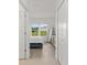Bright bedroom featuring wood floors, a large window, and ample storage space at 19551 Sw 77Th Loop, Dunnellon, FL 34432