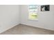Bedroom with hardwood floors, a large window and light-colored walls at 19551 Sw 77Th Loop, Dunnellon, FL 34432