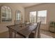 Bright dining room features wood table, rug, chandelier, and natural light through the windows at 19551 Sw 77Th Loop, Dunnellon, FL 34432