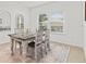 Bright dining room with wooden table, chairs, decor and natural light showcasing an inviting space at 19551 Sw 77Th Loop, Dunnellon, FL 34432
