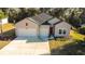 Charming home featuring a three-car garage, neutral siding and manicured lawn at 19551 Sw 77Th Loop, Dunnellon, FL 34432