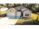 Charming home featuring a three-car garage, neutral siding and manicured lawn at 19551 Sw 77Th Loop, Dunnellon, FL 34432