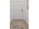 Bright foyer featuring modern flooring and a white door, complemented by a decorative mirror at 19551 Sw 77Th Loop, Dunnellon, FL 34432