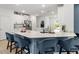 Stylish kitchen with blue accent island, white cabinets, stainless steel appliances, and bar stool seating at 19551 Sw 77Th Loop, Dunnellon, FL 34432