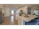 Bright, open kitchen with white cabinets, a central island, and modern appliances at 19551 Sw 77Th Loop, Dunnellon, FL 34432