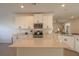 Well-equipped kitchen with a center island, white cabinetry, and modern design at 19551 Sw 77Th Loop, Dunnellon, FL 34432