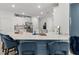 Stylish kitchen with blue accent island, white cabinets, stainless steel appliances, and bar stool seating at 19551 Sw 77Th Loop, Dunnellon, FL 34432