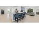 Open-concept kitchen featuring a stylish island with seating, modern appliances, and seamless living space at 19551 Sw 77Th Loop, Dunnellon, FL 34432