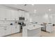 Elegant kitchen featuring modern appliances, white cabinetry, a spacious island, and ample counter space at 19551 Sw 77Th Loop, Dunnellon, FL 34432