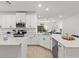 Modern kitchen featuring white cabinetry, sleek appliances, quartz countertops, and ample natural light at 19551 Sw 77Th Loop, Dunnellon, FL 34432