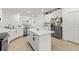 Bright kitchen featuring white cabinets, stainless steel appliances, and a center island for food preparation at 19551 Sw 77Th Loop, Dunnellon, FL 34432