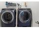 The laundry room features side-by-side washer and dryer units with overhead shelving at 19551 Sw 77Th Loop, Dunnellon, FL 34432