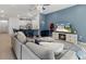 Open concept living room with a fireplace, modern decor, view to the kitchen, and plush seating at 19551 Sw 77Th Loop, Dunnellon, FL 34432