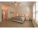 This main bedroom features light wood tile, and a comfortable bed with two end tables at 19551 Sw 77Th Loop, Dunnellon, FL 34432