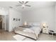 Main bedroom with a ceiling fan, large window, and hardwood floors at 19551 Sw 77Th Loop, Dunnellon, FL 34432