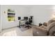 Office space featuring a comfortable chair and recliner with a view of the trees outside at 19551 Sw 77Th Loop, Dunnellon, FL 34432