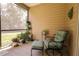 Relaxing screened-in patio with comfortable seating and lush green plants at 19551 Sw 77Th Loop, Dunnellon, FL 34432