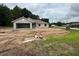 New construction home featuring an attached garage and light gray stucco exterior at 2 Pine Course Trl, Ocala, FL 34472