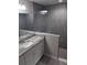 Bathroom featuring tiled shower, white vanity with gray countertop and modern fixtures at 23 Oak Pass Loop, Ocala, FL 34472