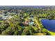 Aerial view of home and community amenities including the pool, tennis courts, and a lake at 2644 Sw 20 Cir, Ocala, FL 34471