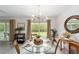Bright dining room with a glass table set, neutral decor, and natural light from the window at 2644 Sw 20 Cir, Ocala, FL 34471